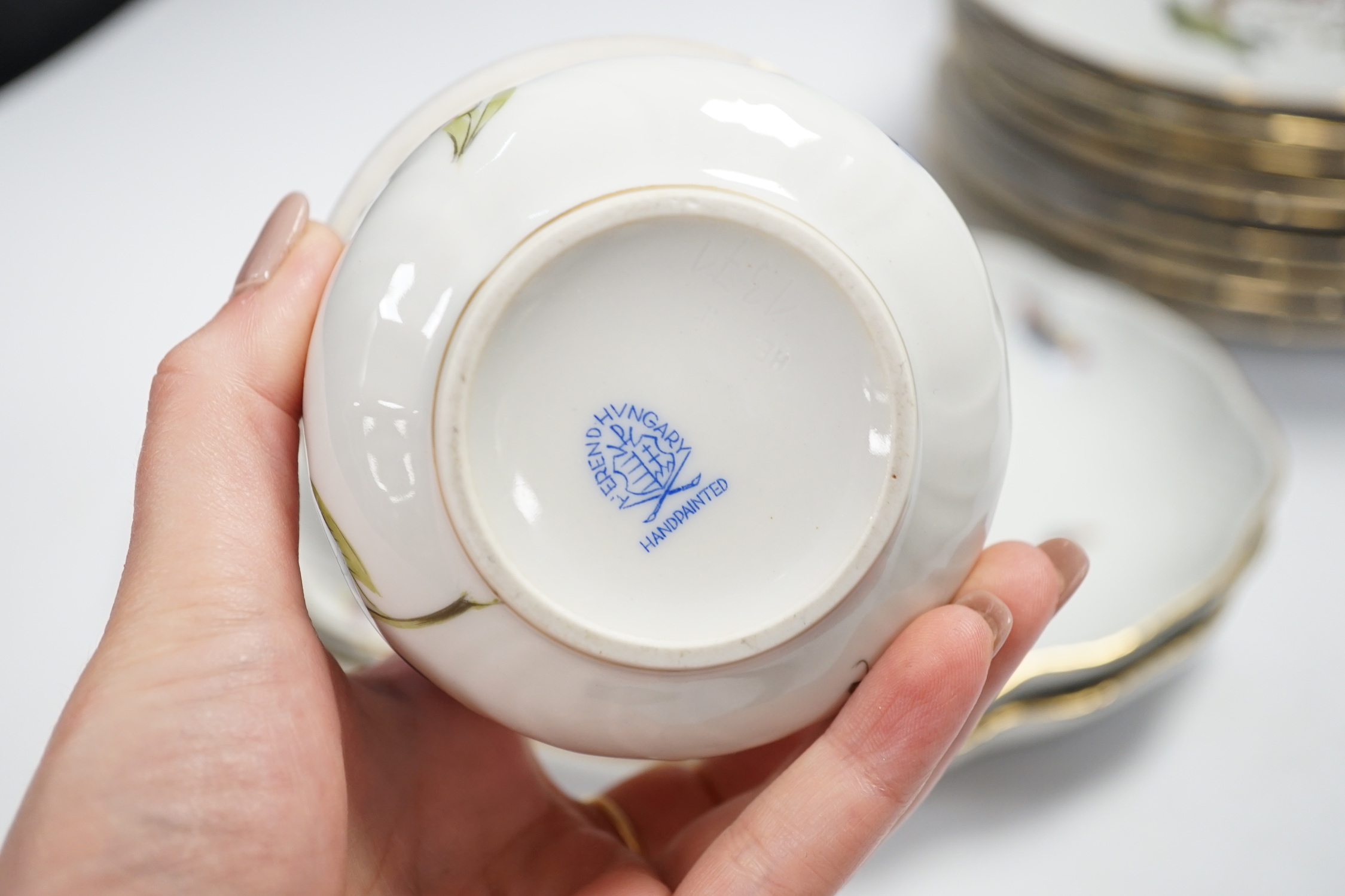 A Herend part dessert service comprising nine plates and two oval dishes together with two bowls, largest 26cm wide